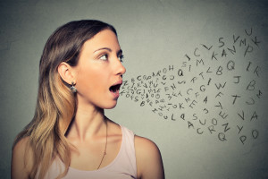 Woman talking with alphabet letters coming out of her mouth